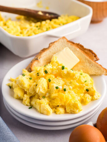 a plate of fluffy scrambled eggs and toast