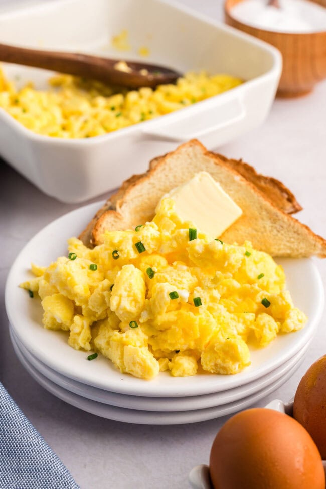 a plate of fluffy scrambled eggs and toast