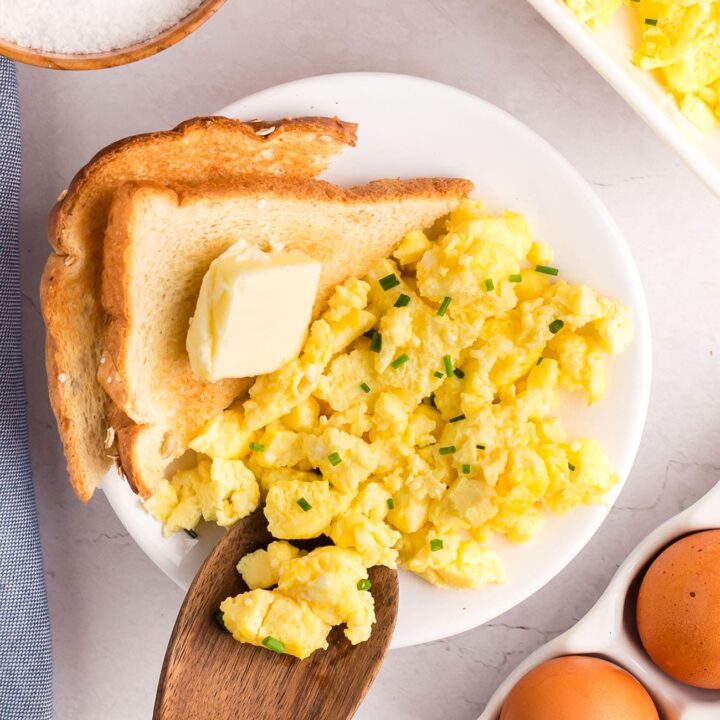 scrambled eggs on a plate with toast