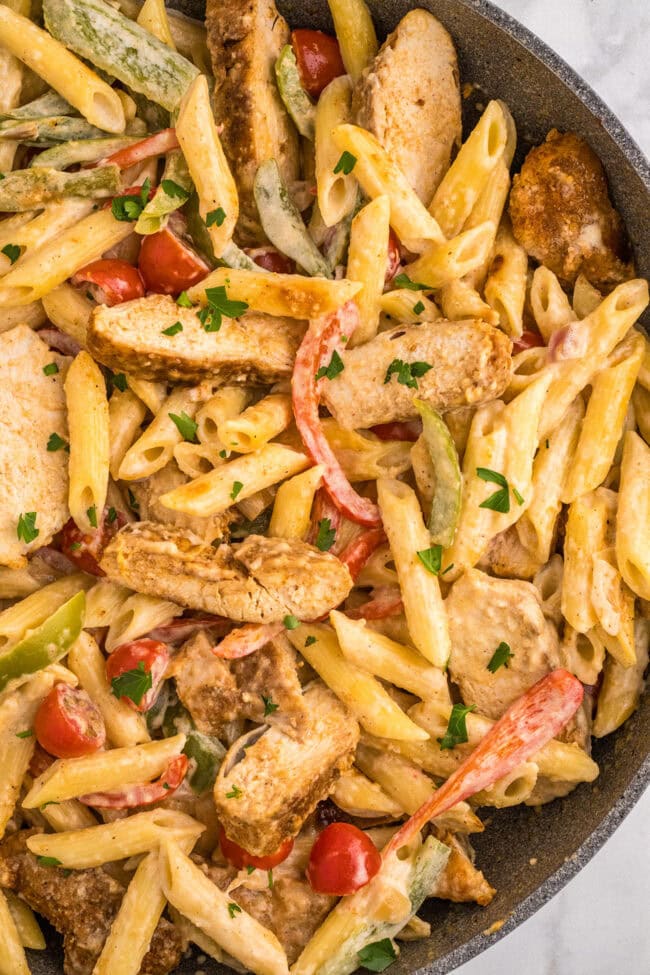 close up of penne pasta with chicken and veggies