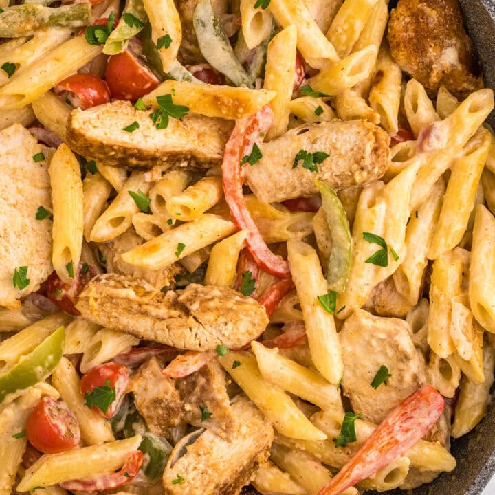 close up of penne pasta with chicken and veggies