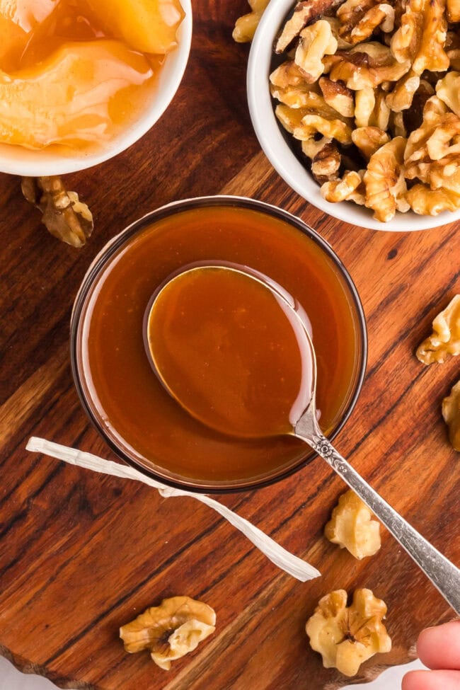 Homemade salted caramel sauce in a jar with a spoon