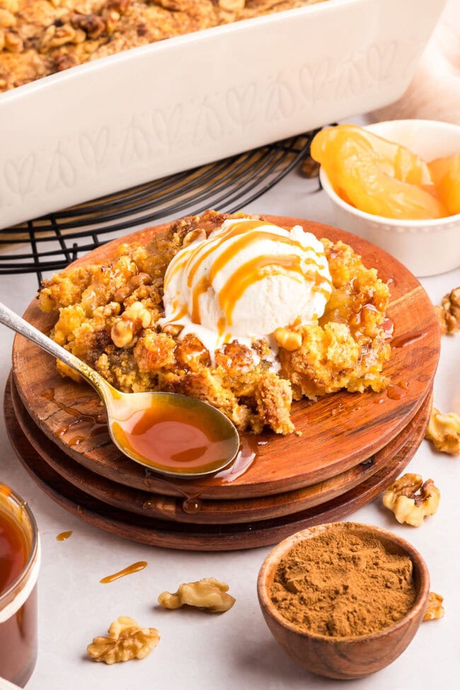 apple dump cake with caramel sauce and a scoop of ice cream