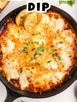 hot Lasagna Dip served in a cast iron skillet with baguettes