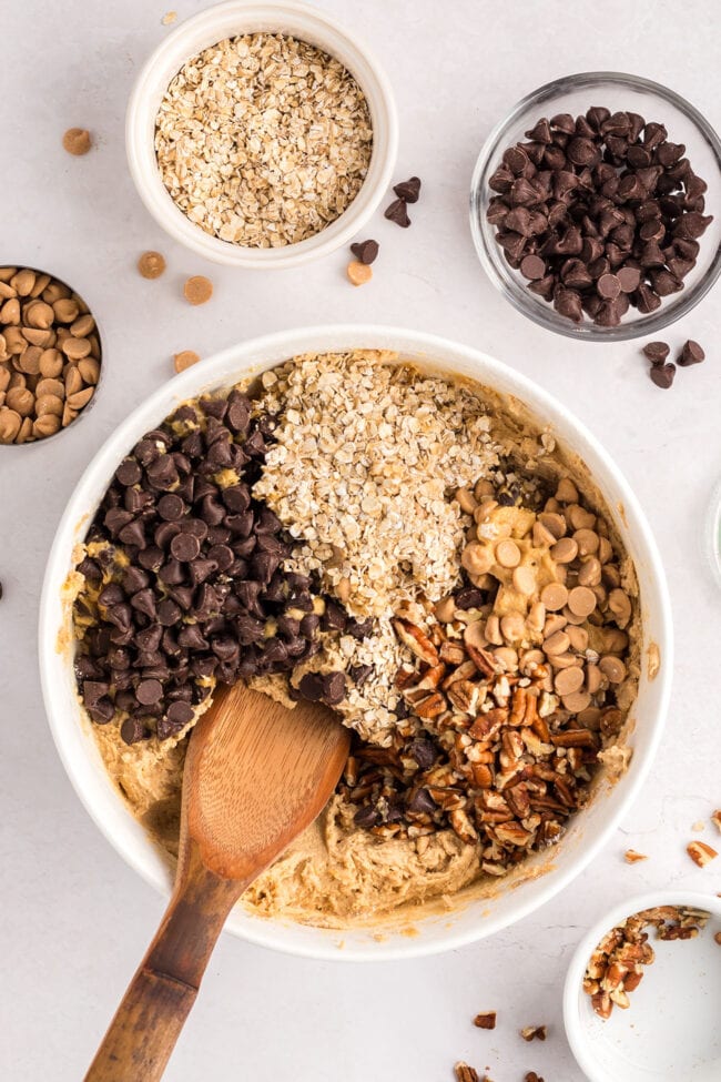 loaded cookie dough in a bowl with a wooden spoon