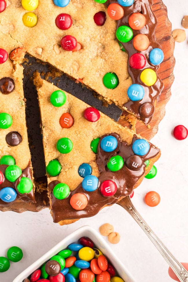 overhead shot of a slice of peanut butter cookie cake with M&M candies