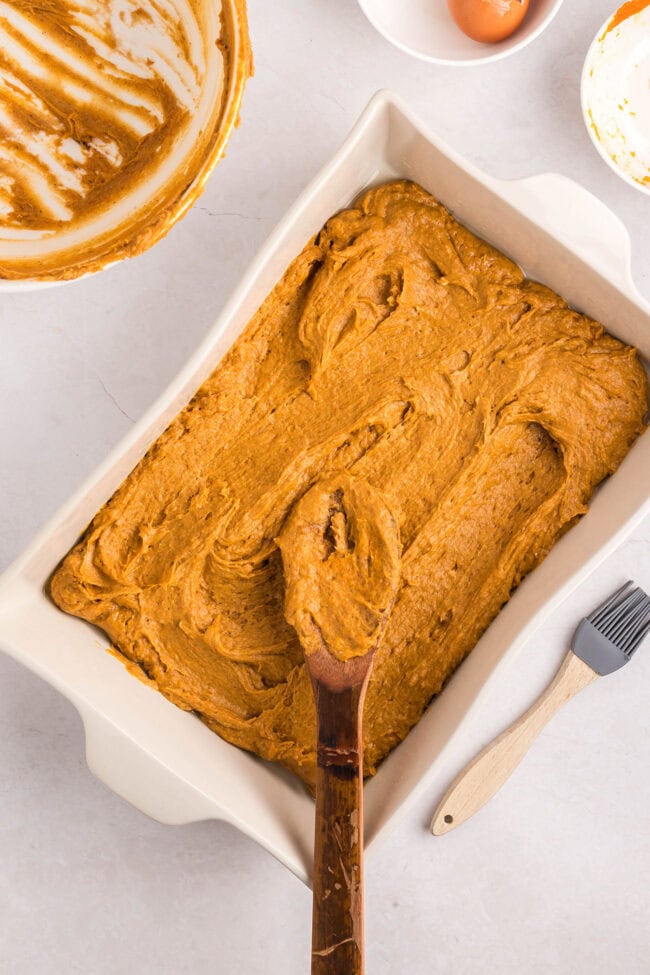 pumpkin cake batter in a white 9x13 dish