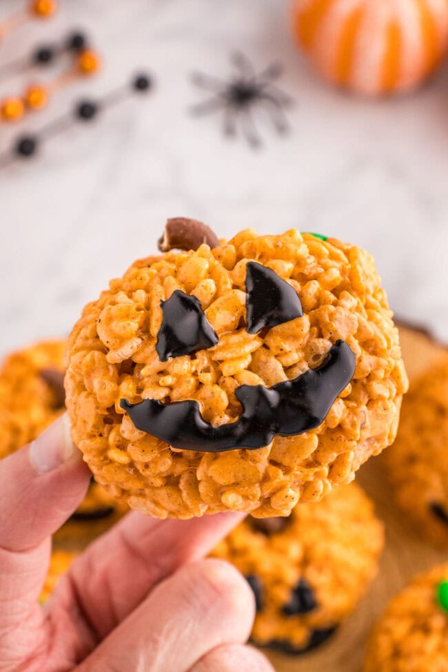 woman's hand holding a Pumpkin Rice Krispie Treats