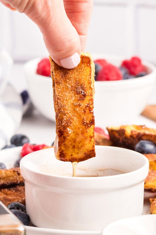 Homemade French Toast Stick being dipped in syrup