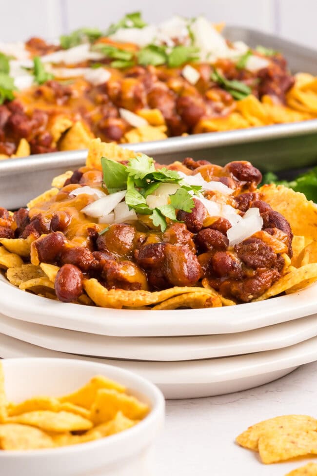 Fritos with chili and cheese on plates