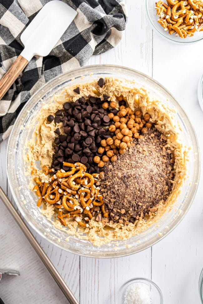 glass mixing bowl with cookie dough and all of the mixins