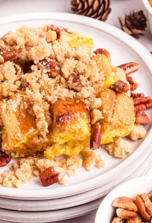 baked french toast with pecans on a white plate