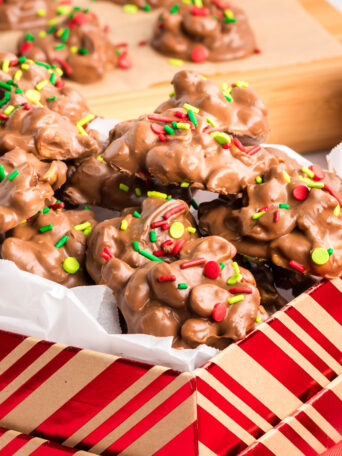 peanut clusters with Christmas sprinkles in a holiday box