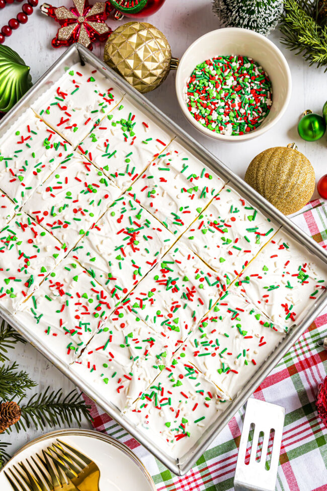 Christmas poke cake with sprinkles in the pan.