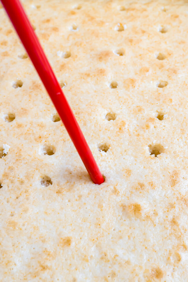 poking holes in a baked cake