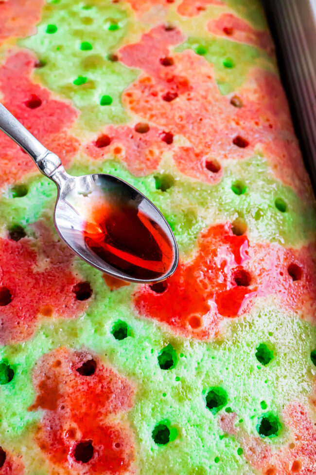 pouring liquid jello over baked cake