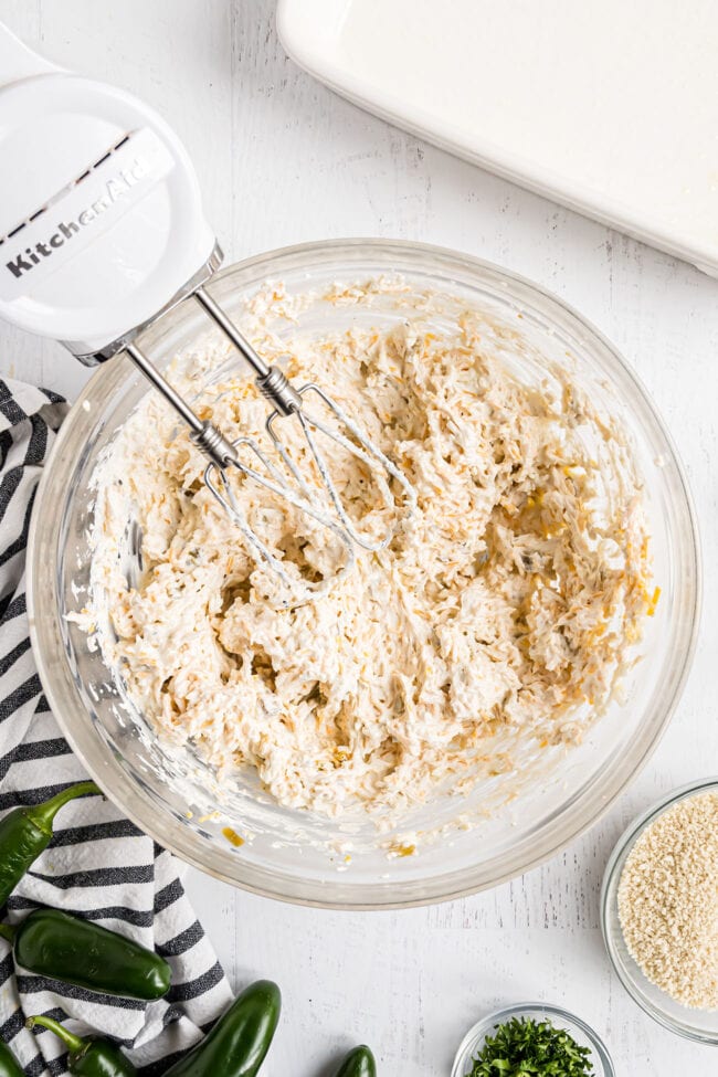 mixing Jalapeño cheese Dip in a glass bowl