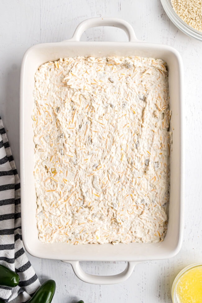 cheese dip spread out in a baking dish