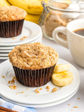 banana muffin with crumb topping on a plate