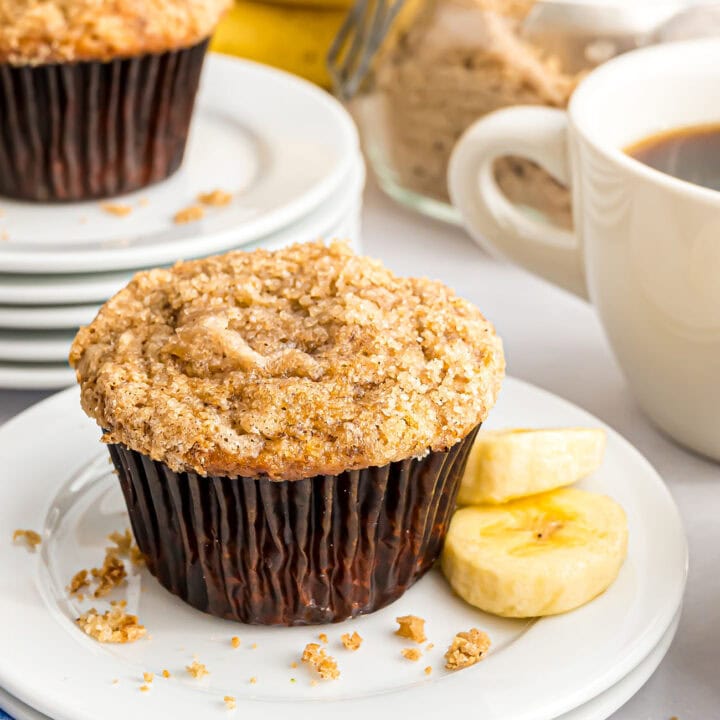 banana muffin with crumb topping on a plate