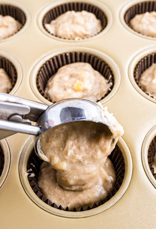 scooping batter into a muffin tin using a cookie scoop