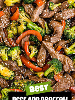 beef and broccoli with bell peppers in a pan