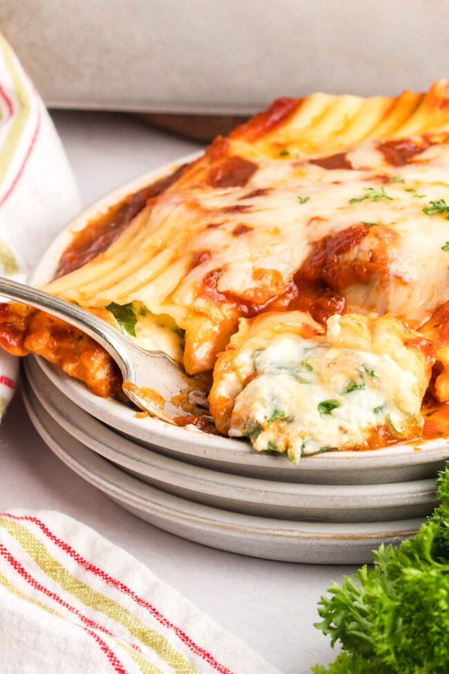 manicotti on a plate with a fork