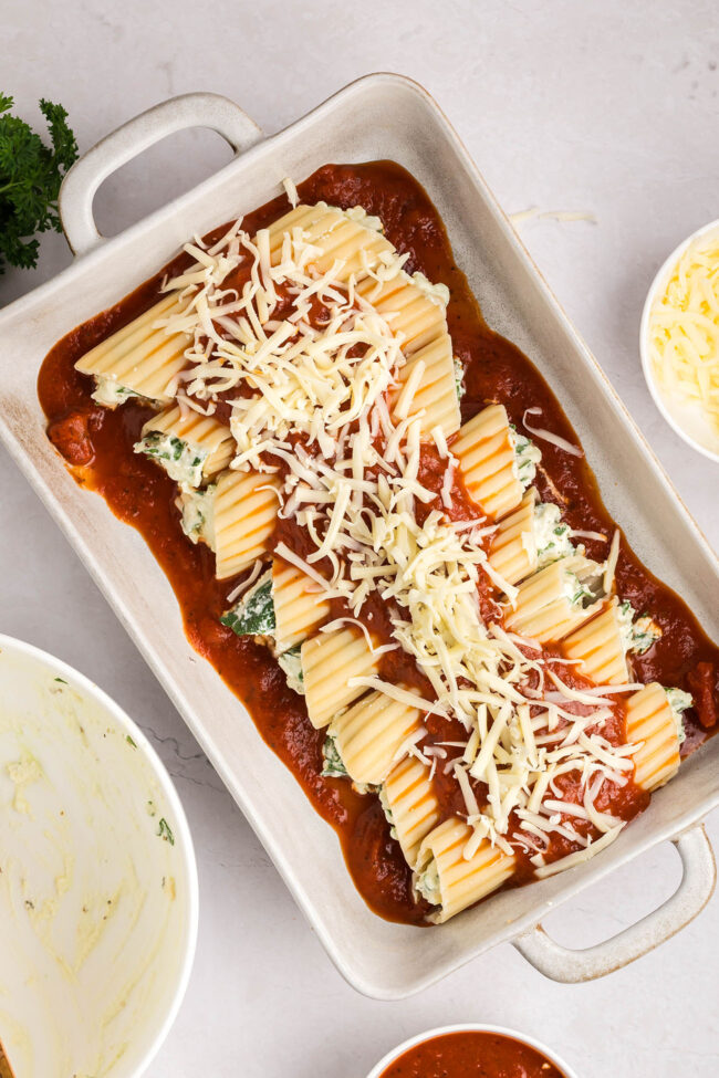 cheese manicotti in a white baking dish ready for the oven