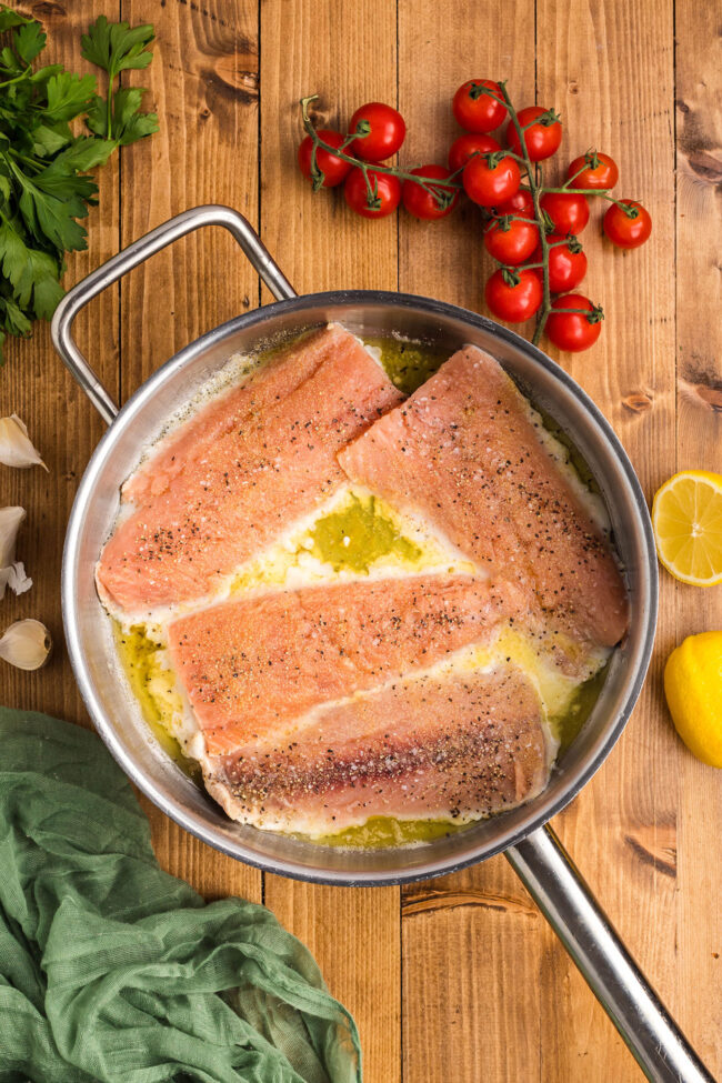 salmon cooking in a skillet