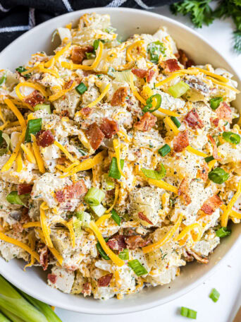 white bowl filled with loaded baked potato salad