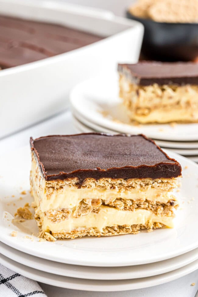 easy eclair cake with layers of pudding and graham crackers with chocolate ganache on top