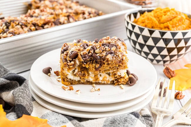 Pumpkin Earthquake Cake with pure pumpkin in a small bowl in the background and the baked dessert in a pan