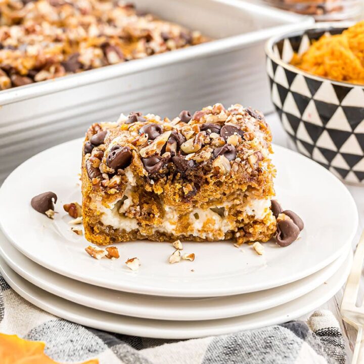 Pumpkin Earthquake Cake with pure pumpkin in a small bowl in the background and the baked dessert in a pan