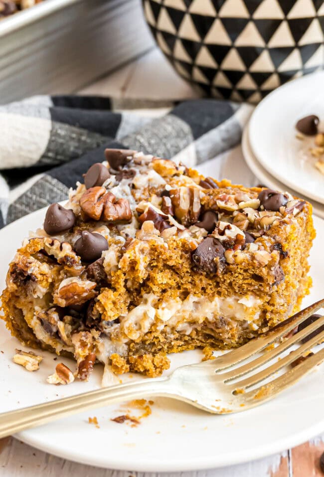 Earthquake Cake with pumpkin cut into a serving on a small plate with a fork