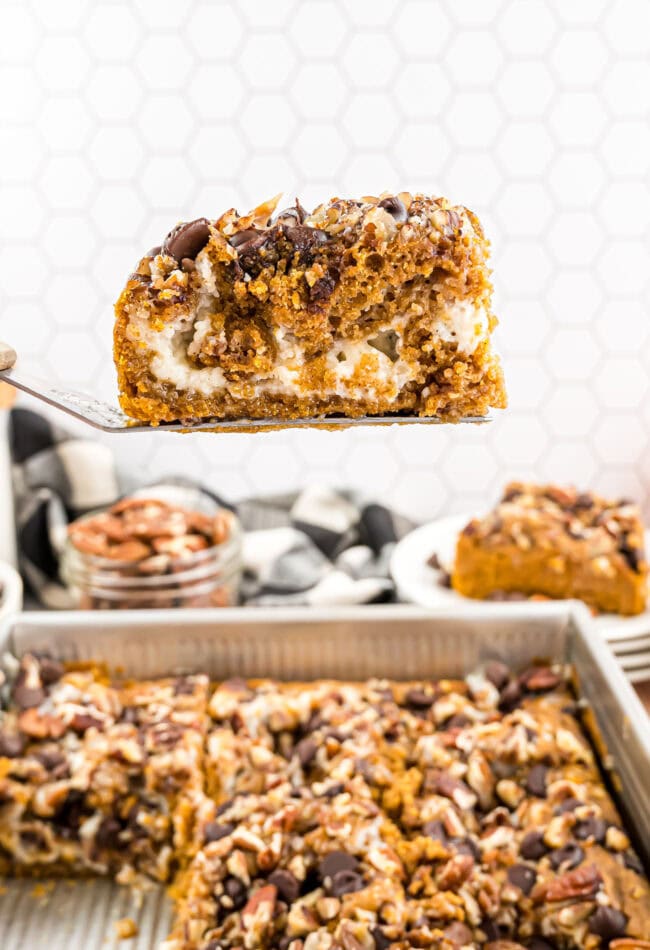 baked Pumpkin Earthquake Cake with a serving on a spatula