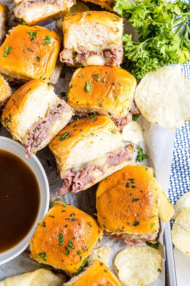 Golden, buttery sliders baked on soft Hawaiian rolls with a side of au jus