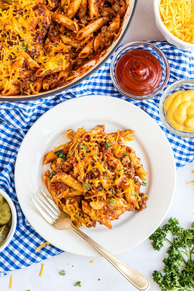 Skillet full of cheesy bacon pasta with ground beef and penne pasta, ready to serve.