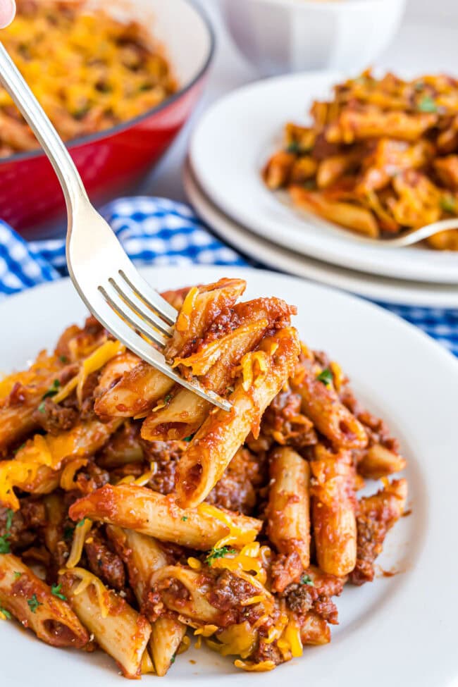 Family-style plating of Bacon Cheeseburger Pasta Skillet in blue and white linens.