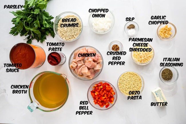 ingredients for Slow Cooker Chicken Parmesan Soup showing tender chicken, pasta, and rich tomato broth.