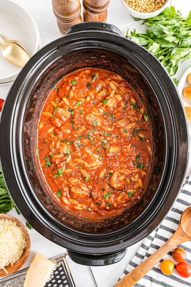 Slow cooker filled with Chicken Parmesan Soup ready to serve.