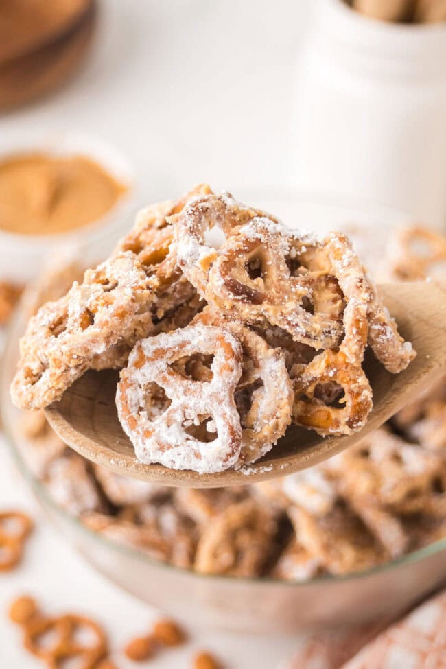 Peanut Butter Pretzel Snack Mix on a wooden spoon
