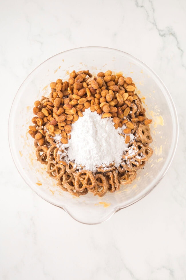 pretzel twists and roasted peanuts ready to add to melted peanut butter and chocolate