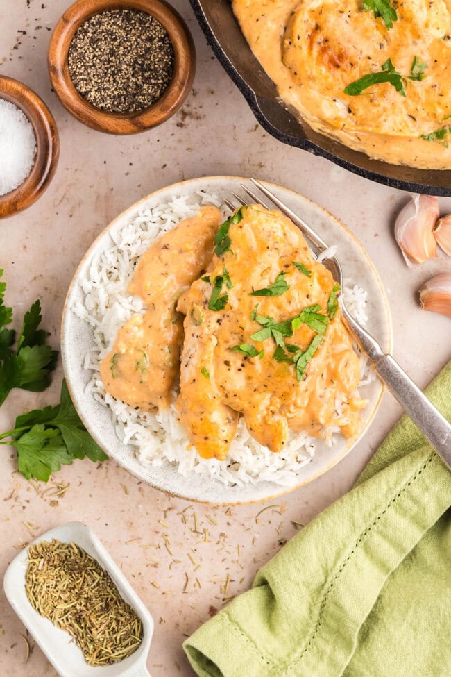 Family-style serving of one-skillet smothered chicken with garnished parsley.