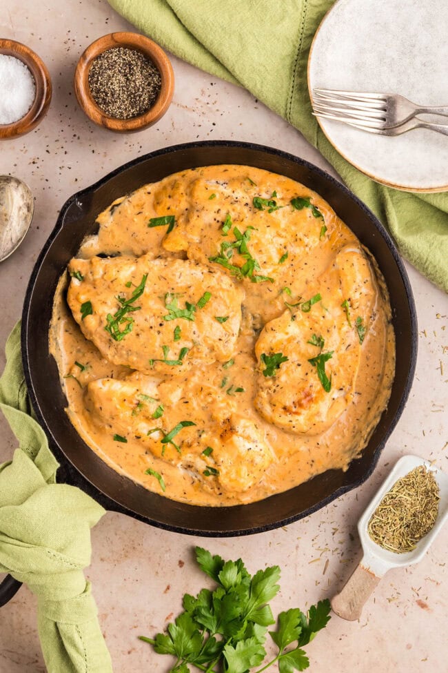 One-skillet smothered chicken with creamy Parmesan sauce ready to serve.