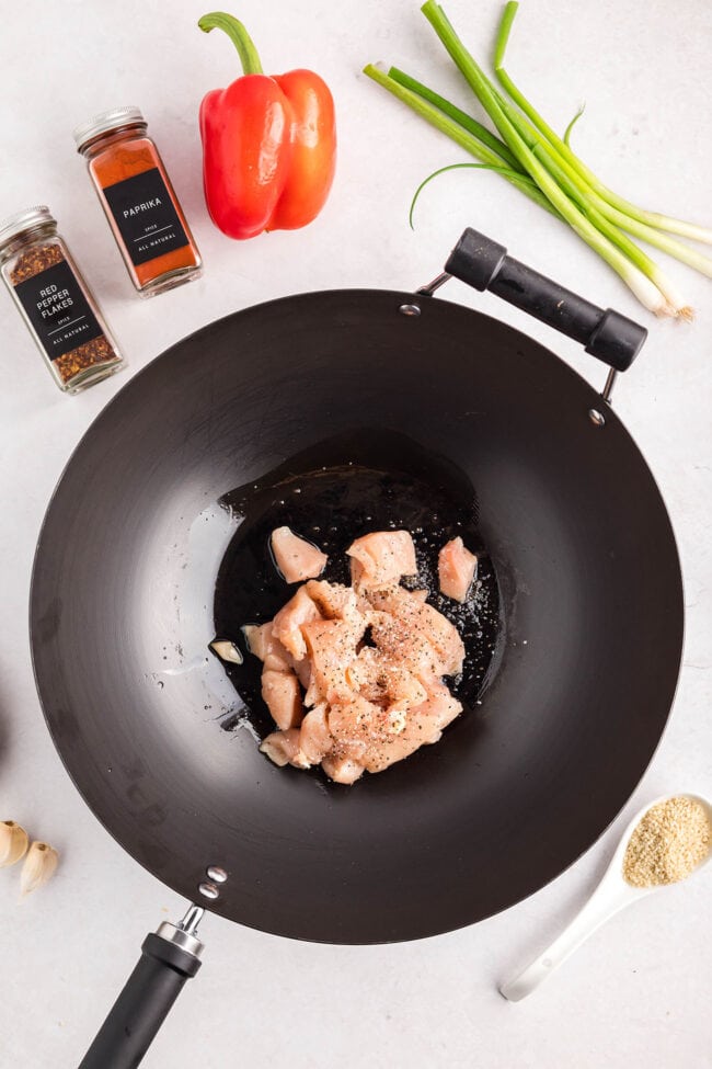 Cashew Chicken Stir Fry cooking in a wok with chicken, broccoli, red peppers, and cashews — step-by-step process from start to finish.