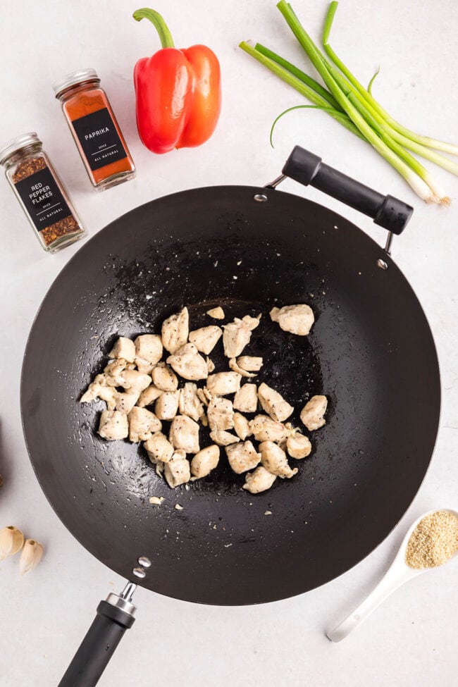 Cashew Chicken Stir Fry cooking in a wok with chicken, broccoli, red peppers, and cashews — step-by-step process from start to finish.