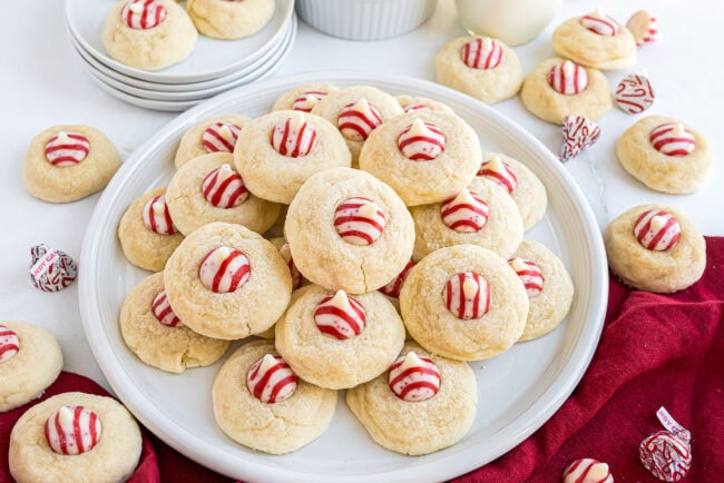 Side view of a plate stacked with Candy Cane Kiss Cookies, ready for serving.
