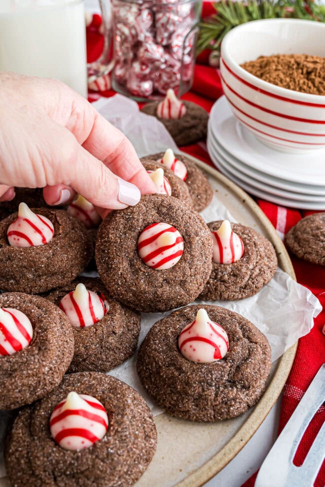 Hand holding a baked Chocolate Peppermint Kiss Cookie.