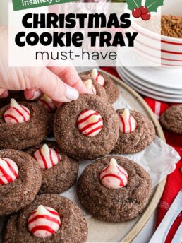 Chocolate Peppermint Kiss Cookies arranged on a Christmas cookie tray with striped peppermint Kisses for a festive holiday presentation.