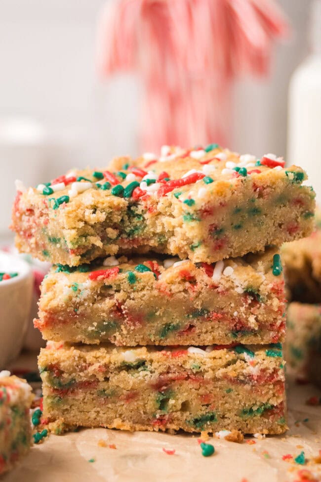 Close-up of stacked Christmas Blondies highlighting the chewy center and festive sprinkles.